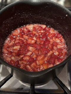 Homemade strawberry jam cooking in a pan, make from fresh strawberries for a sweet, thick fruit spread