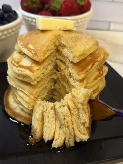 Homemade buttermilk pancakes cut into pieces on a fork
