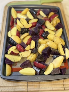 Potatoes cut into wedges and seasoned with olive oil, salt, and pepper.
