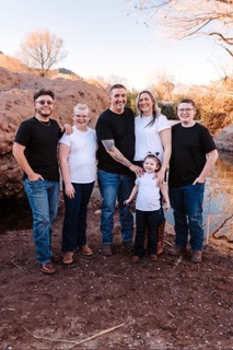 Family posing together outdoors in the desert surrounded by desert landscaping, inspiration for homemade from scratch recipes.