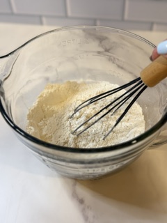 Dry ingredients being whisked together in a bowl for homemade buttermilk pancakes