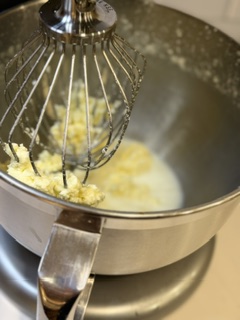 Separated homemade butter and buttermilk in a mixing bowl