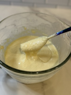 Wet and dry ingredients being mixed together to make homemade buttermilk pancakes